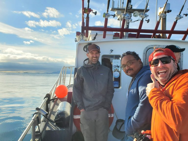 John and other AMC employees on fishing boat