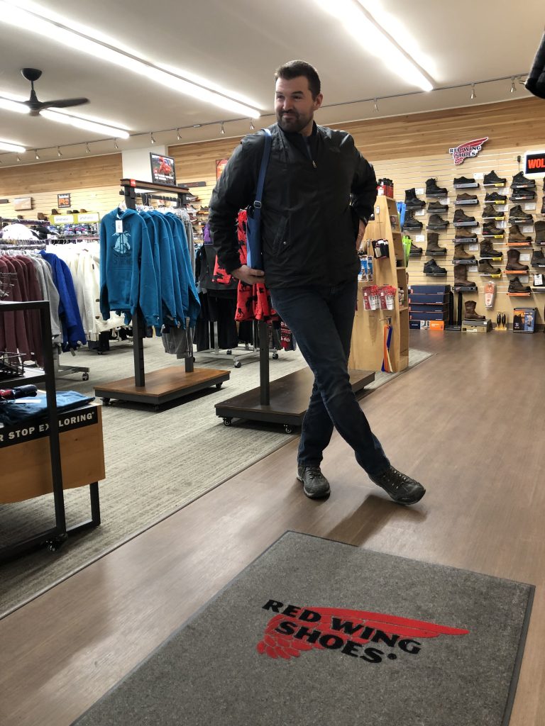 Aaron posing in a clothing store