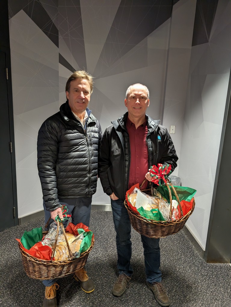 Dave and Ken Ratcliffe holding gift baskets