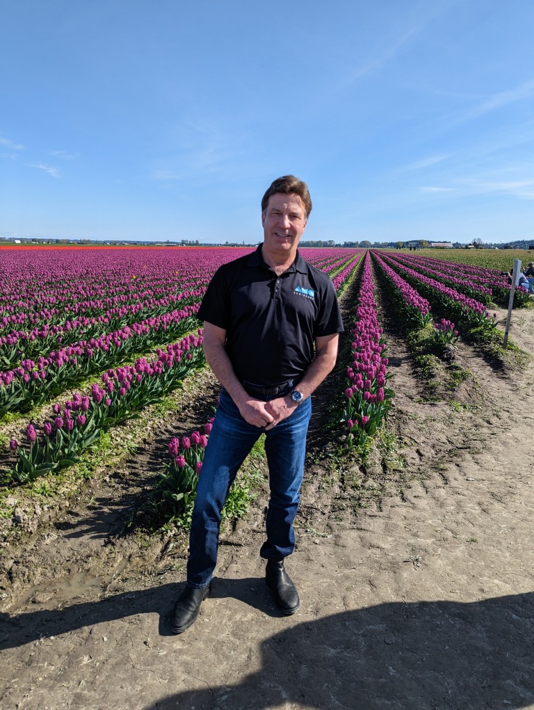 Dave standing in flower field