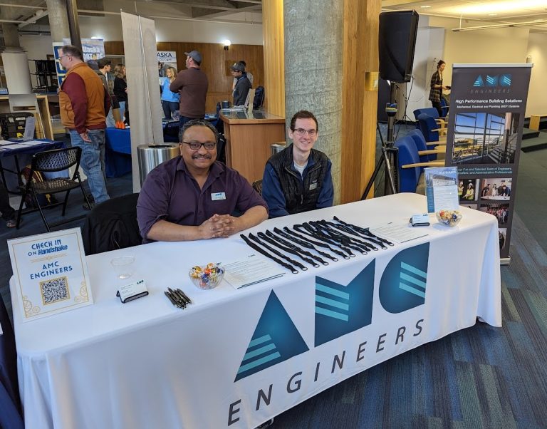 John sitting at careers booth for AMC engineers