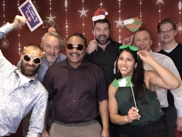 Multiple AMC employees posing with Christmas props