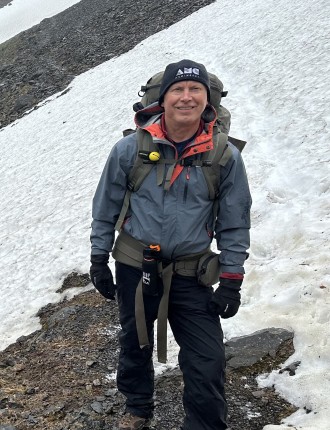 Ken hiking on a snowy mountain