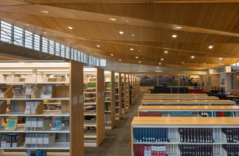 Dim lighting and decorative ceiling panels in library