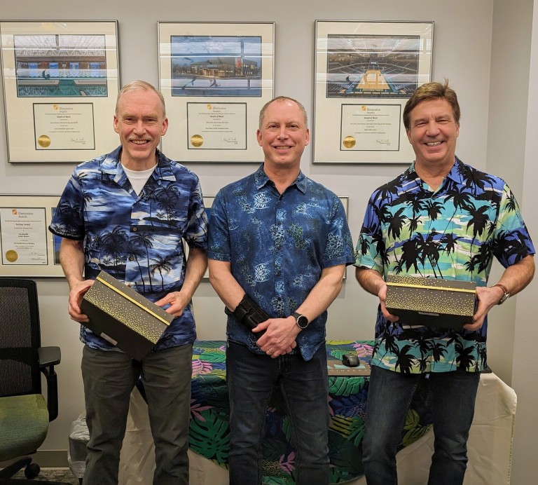 Three AMC employees in tropical shirts