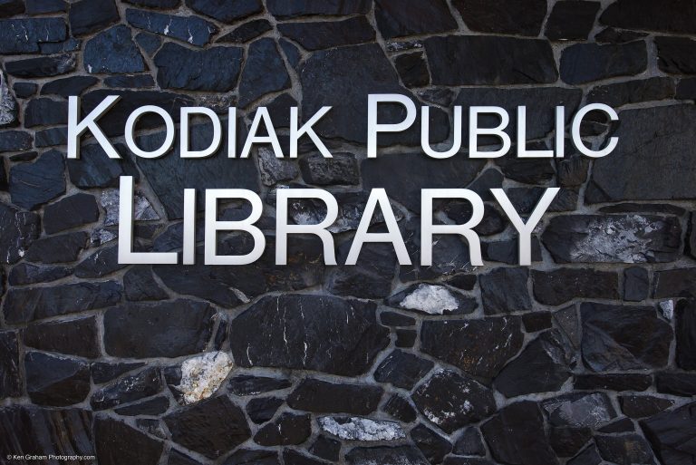 Metal letters on black stone wall for Kodiak Public Library