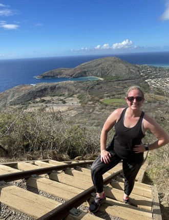 Brittany hiking up a rail on a mountain side