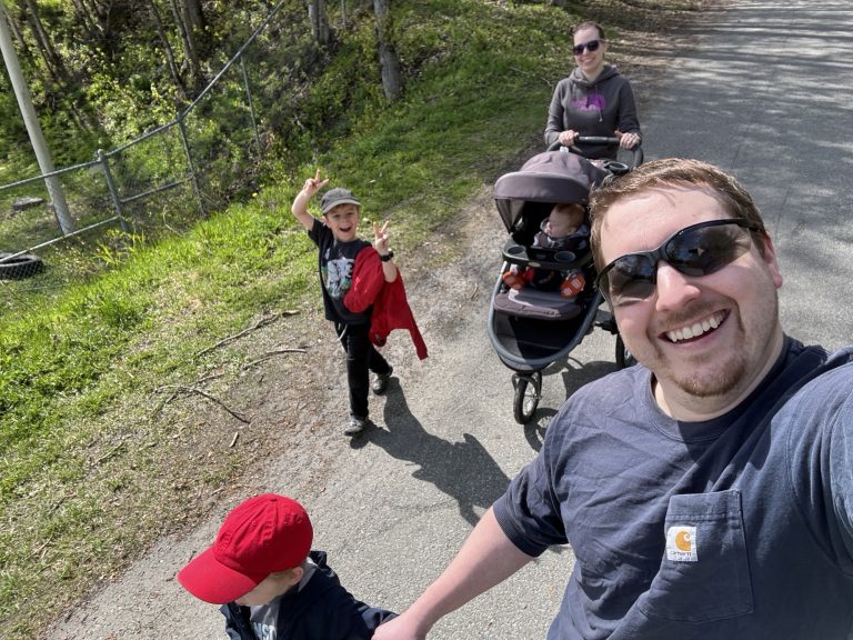 Christian walking a trail with his family