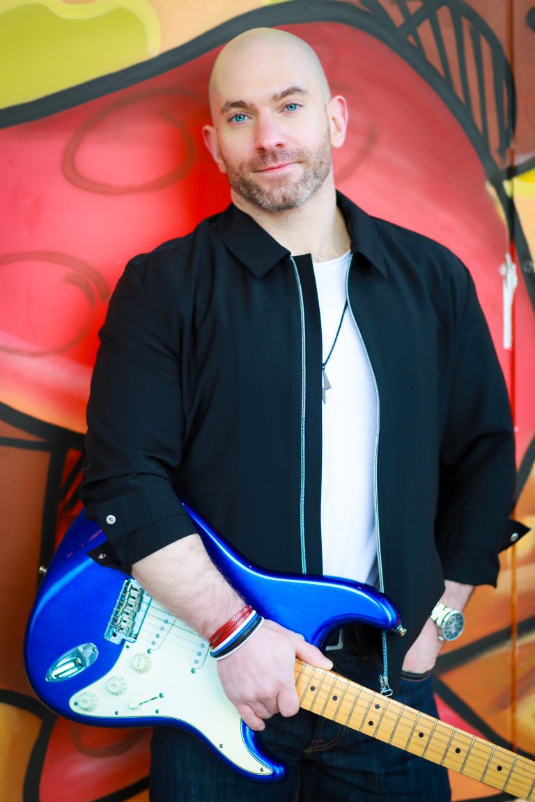 David holding an electric guitar