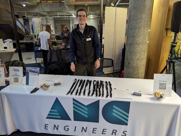 Dylan standing at an AMC engineers career booth
