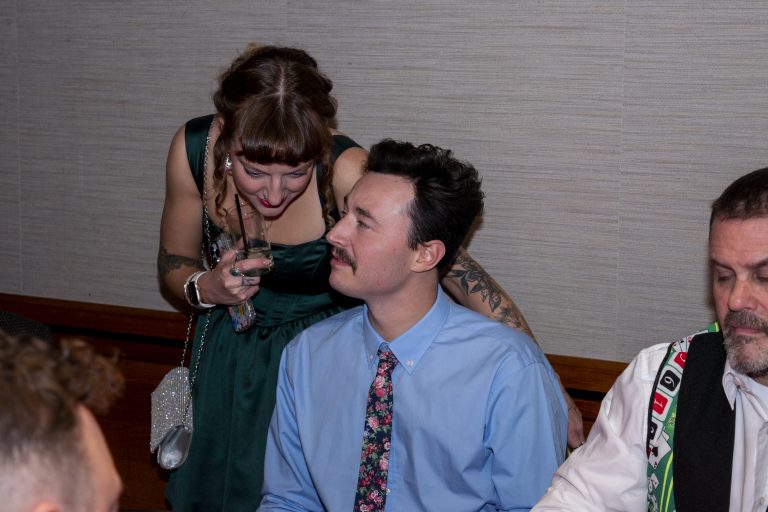 Christopher talking with a woman at a formal event