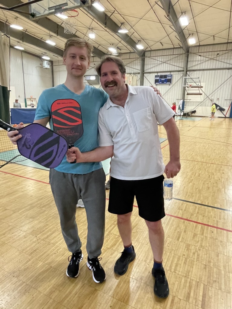 Sam Berdahl playing pickleball with another man