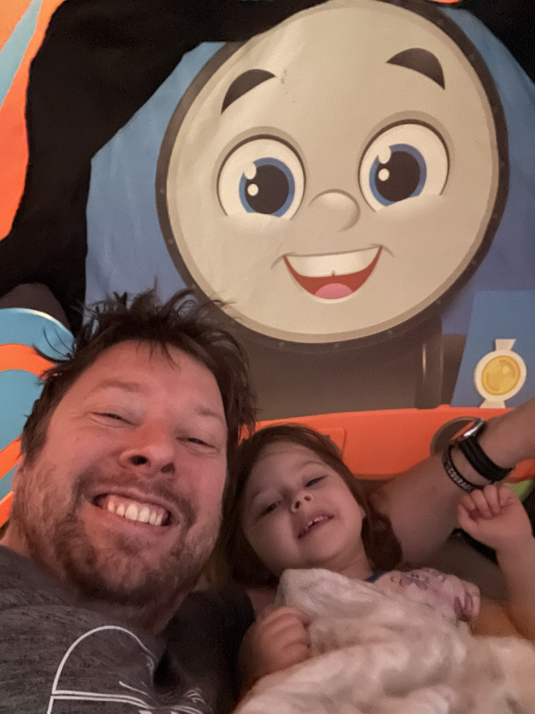 Tyler smiling with a young girl