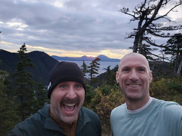Two AMC employees hiking a mountain trail