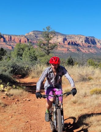 John biking along trail in the mountains