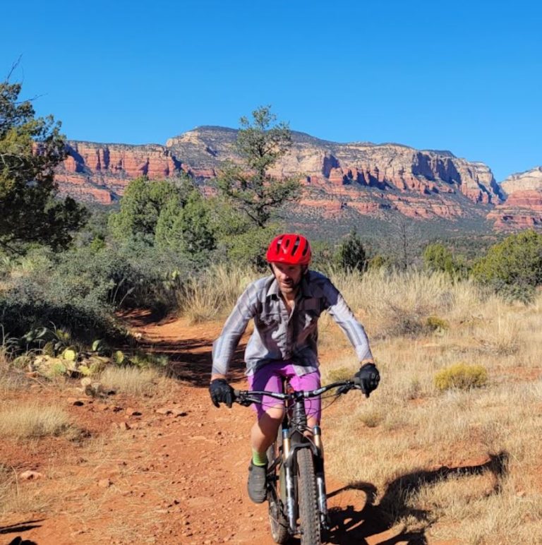 John biking along trail in the mountains