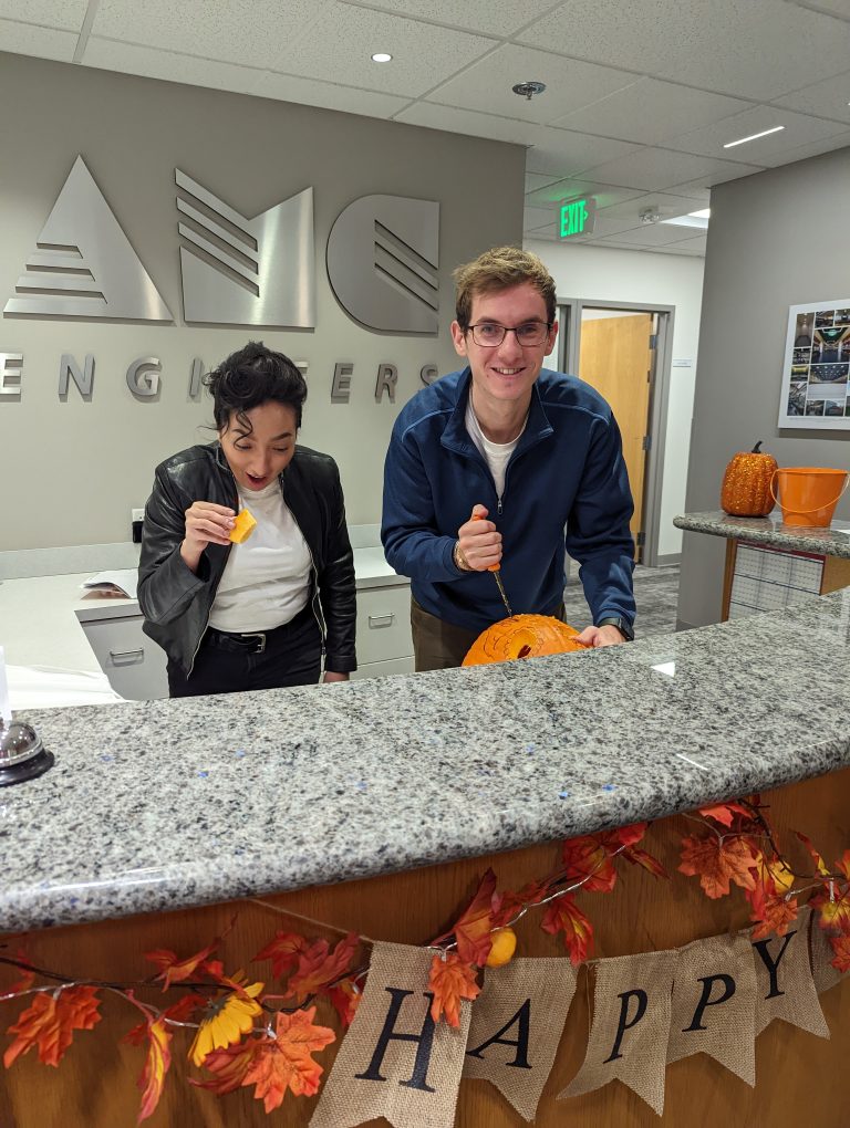 Dylan and another AMC employee carving pumpkins