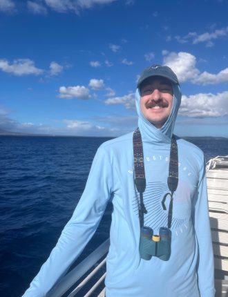 Kyle smiling on a boat