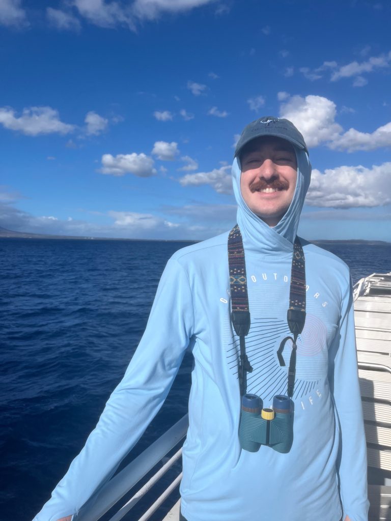 Kyle smiling on a boat