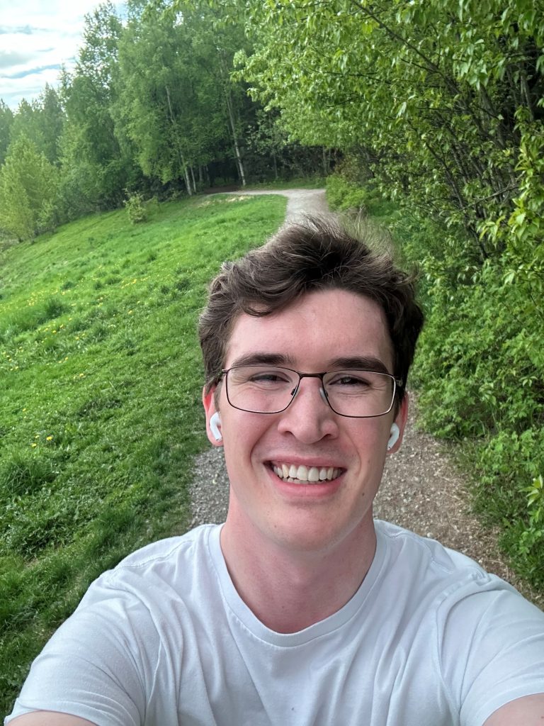 Logan walking along wooded trail