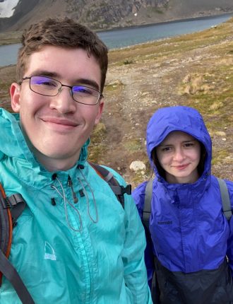 Logan and young girl hiking mountains