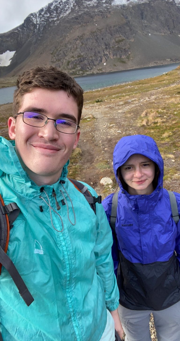Logan and young girl hiking mountains