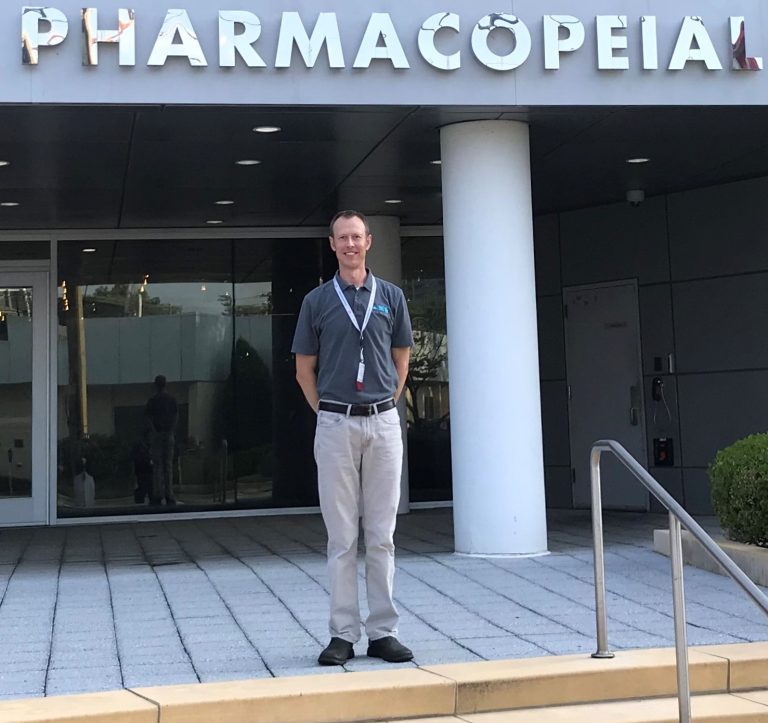 Matt standing on steps in front of building