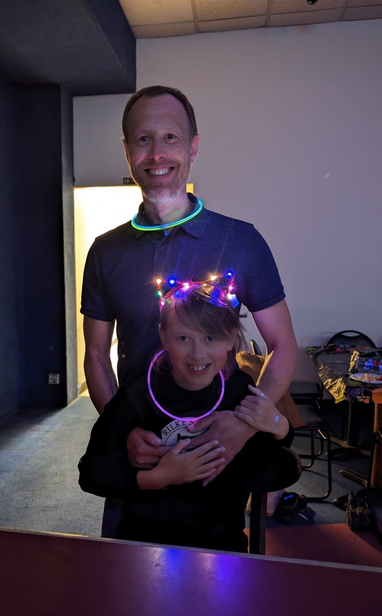 Matt wearing glowstick necklace with young girl