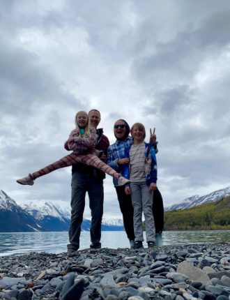 Matt and woman posing with two children