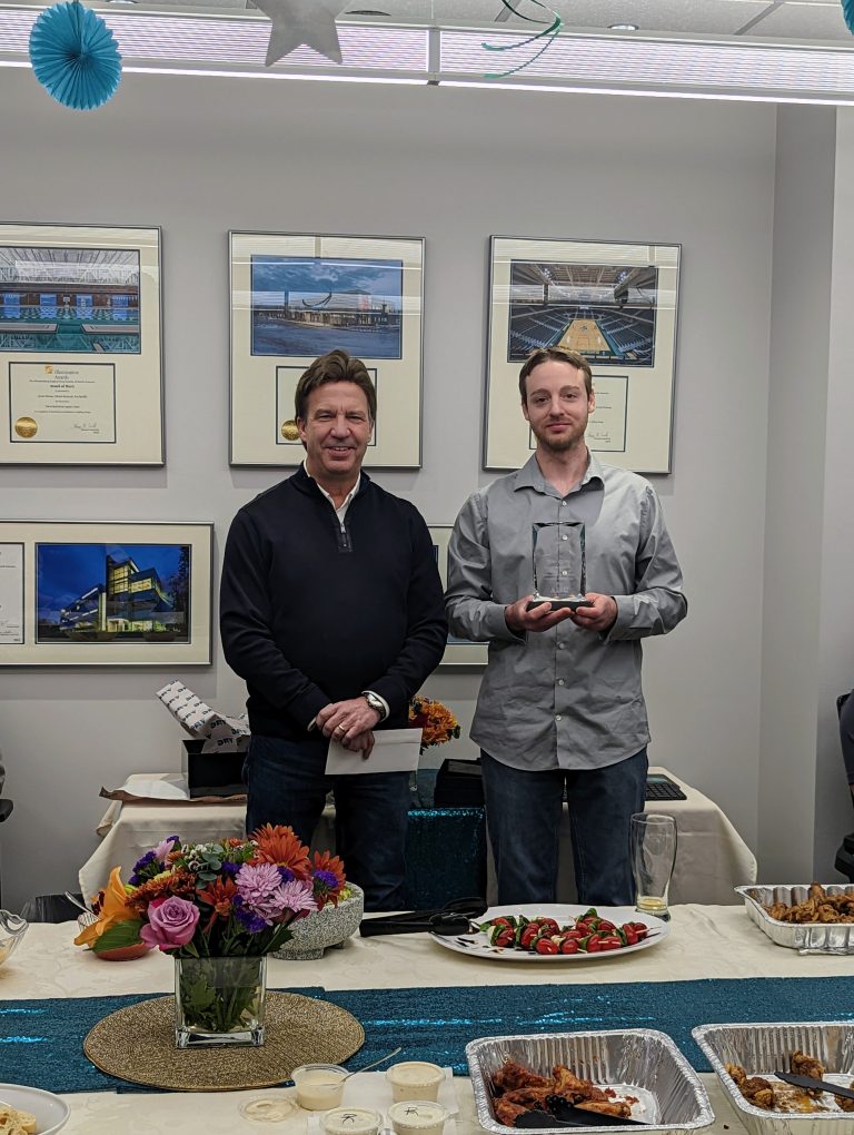 Tyler holding a placard with Dave Shumway during a lunch