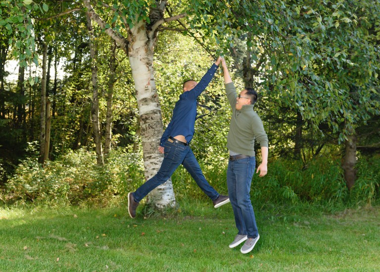 Marlon Lontoc jumping high and high fiving another AMC employee