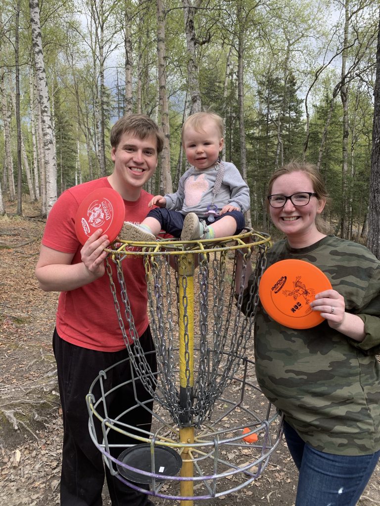 Trenton posing with a woman and baby