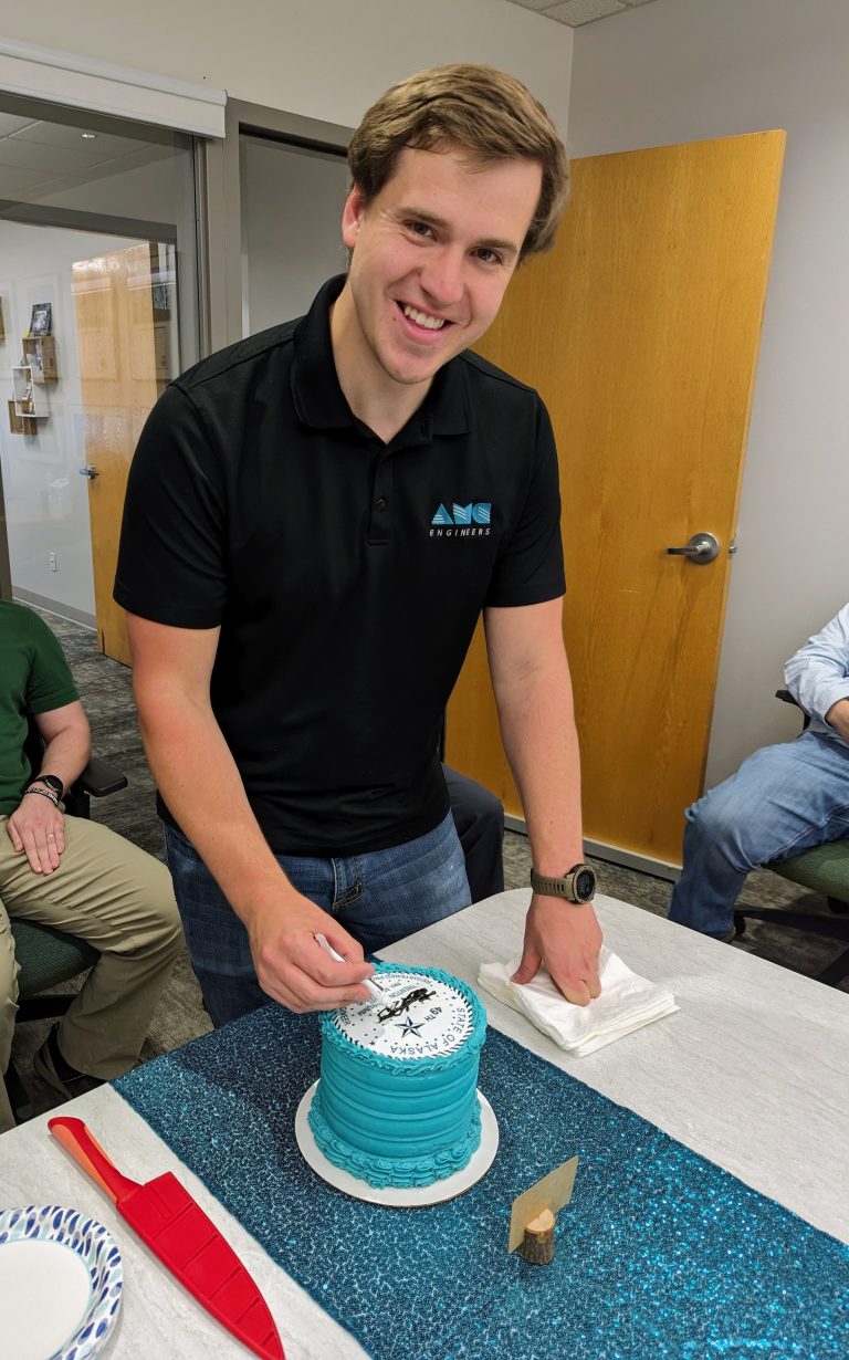 Trenton cutting a cake at a celebration