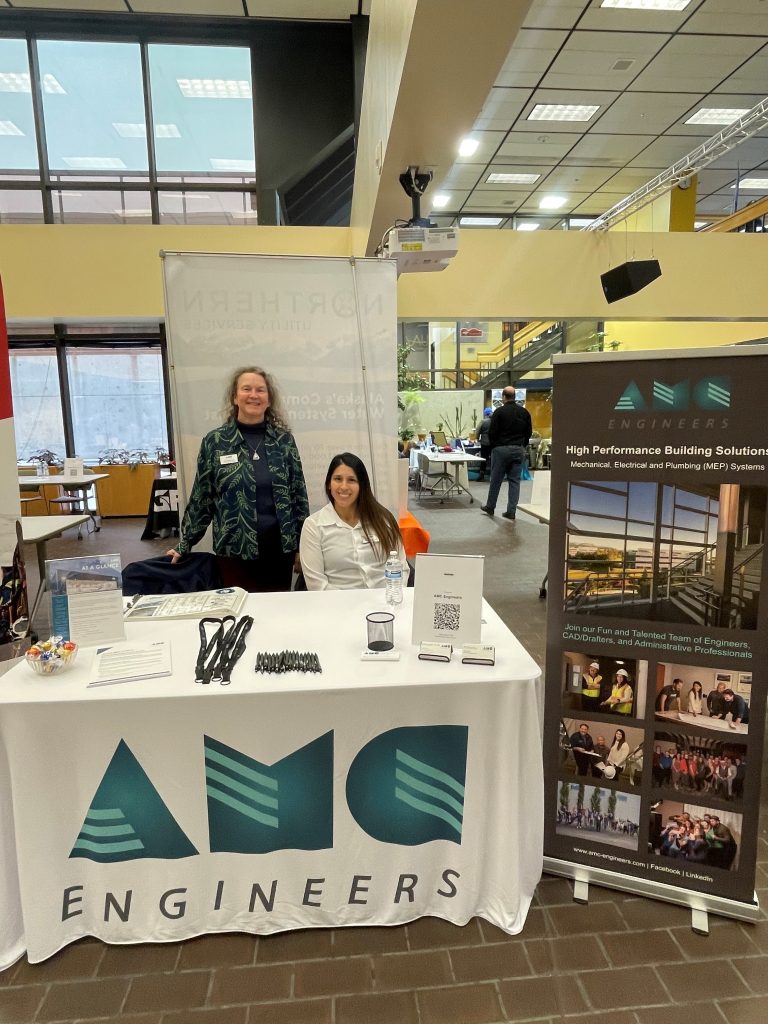 Tami and another AMC employee at a booth
