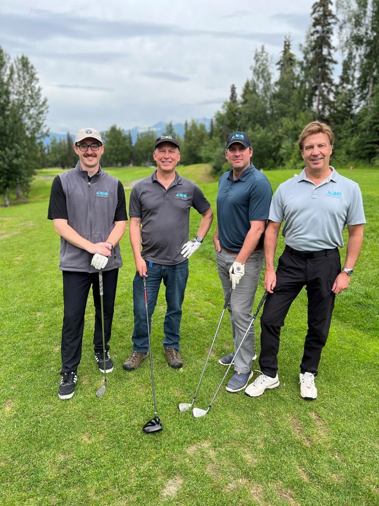 Four AMC employees golfing