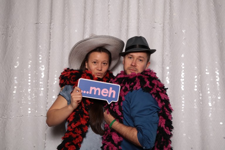 Bart and a woman standing in front of a glittery backdrop with props