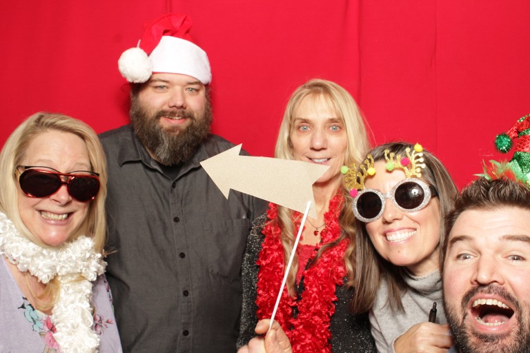 Multiple AMC employees in photo booth with fun props