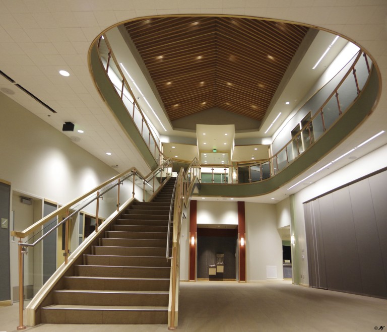 Stairwell and second story with glass railings, and ceiling with decorative lighting