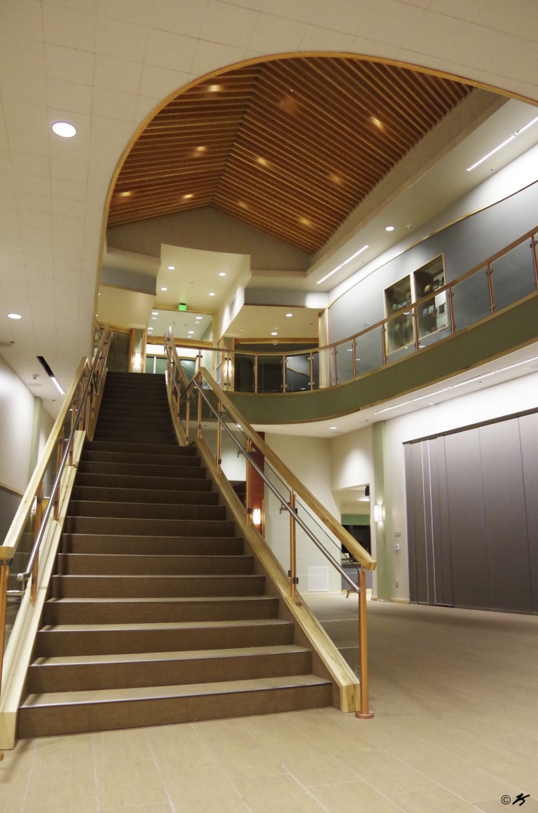 Stairwell and second story with glass railings, and ceiling with decorative lighting