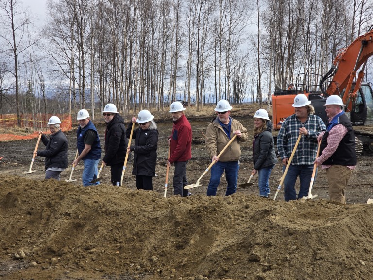 AMC employees digging together in field