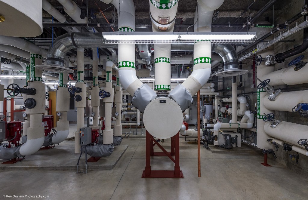 Large pipes and machinery covering all walls in large room