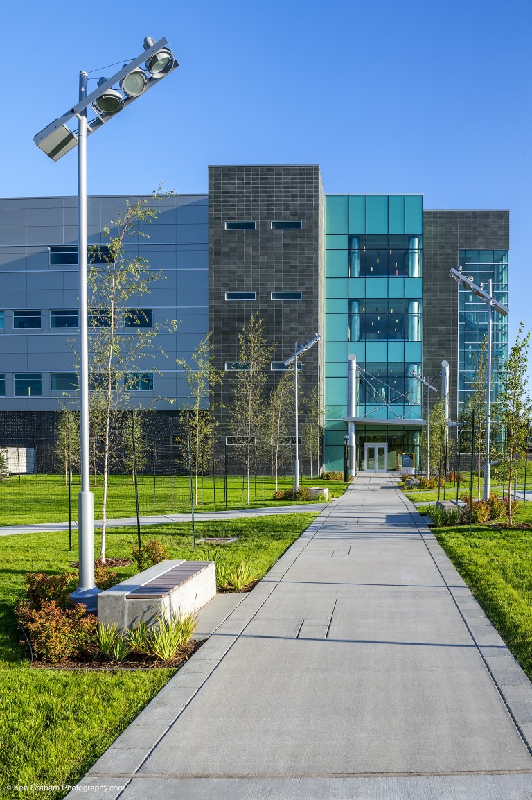 Lit walkway into multistory building