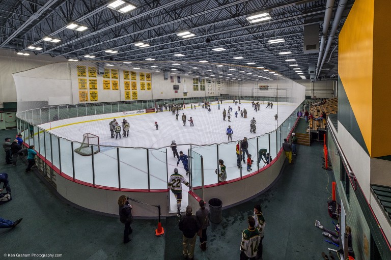 People skating on brightly lit ice rink