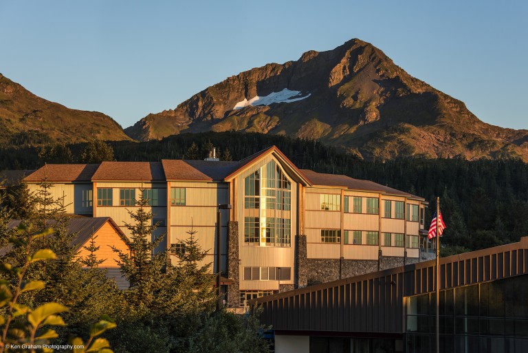 Multistory stone brick and wooden slab building nestled in a wooded mountainside