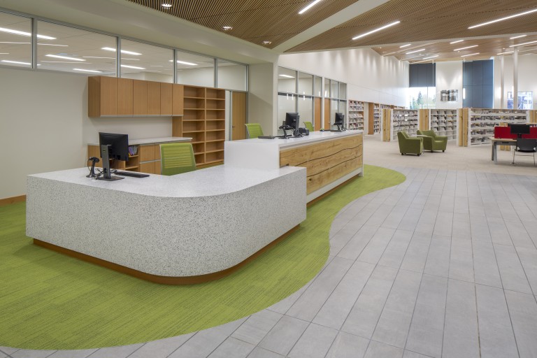 Brightly lit library with wood grated ceilings