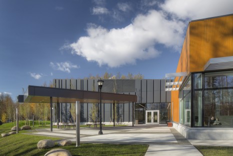 Exterior of building with lit covered patio