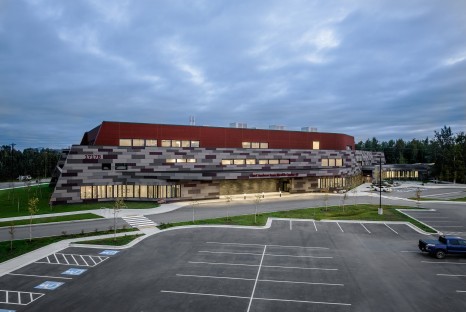Exterior of multistory building with red and gray colorful tile walls
