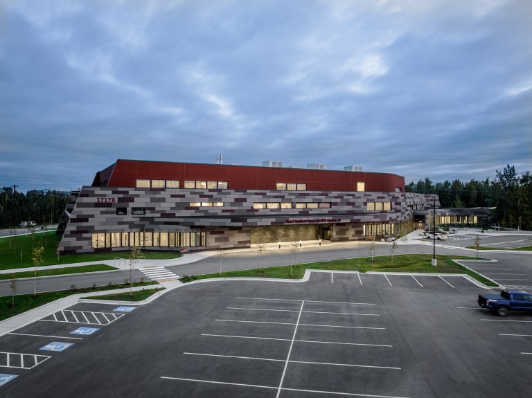 Exterior of multistory building with red and gray colorful tile walls