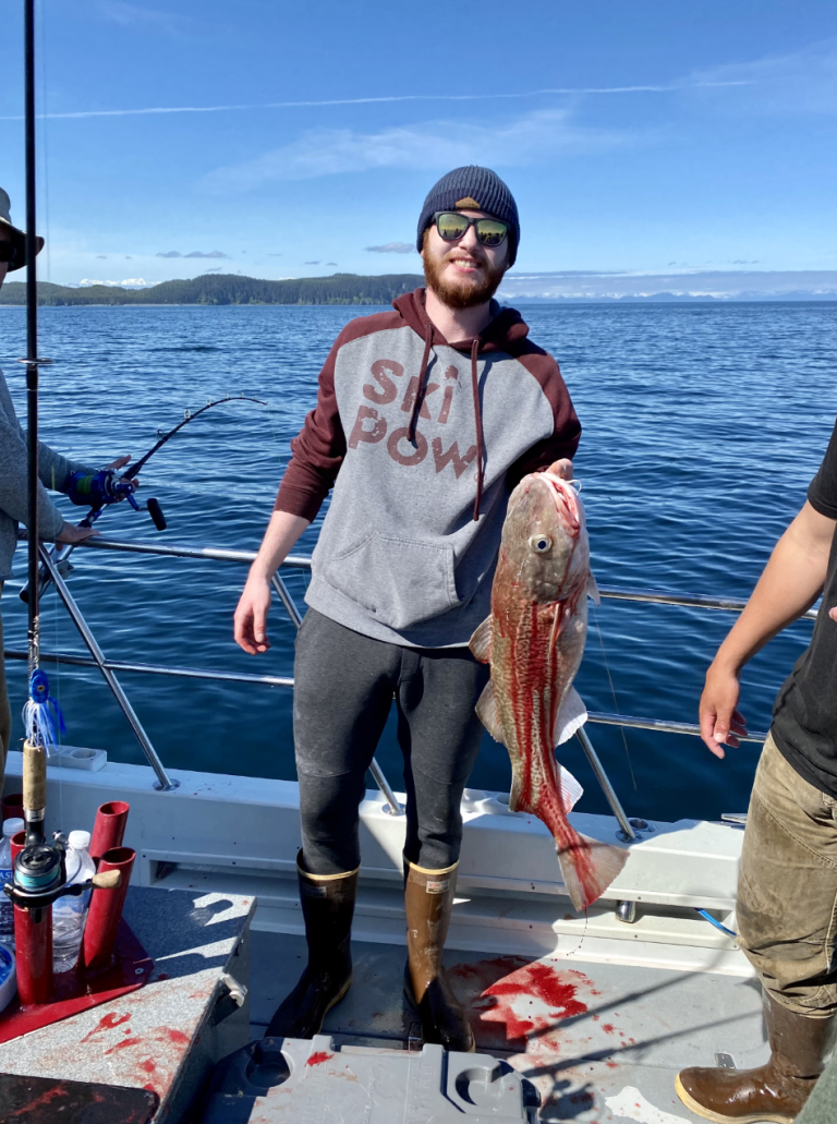 Jack Schumacher holding large fish on a boat