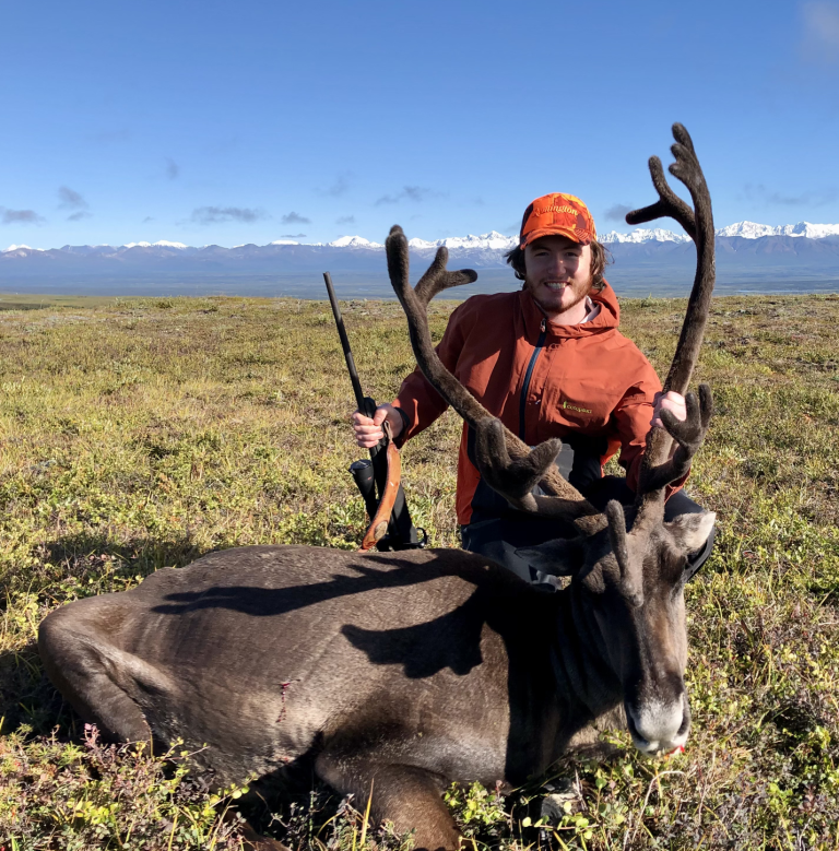 Jack Shumacher posing with deceased moose